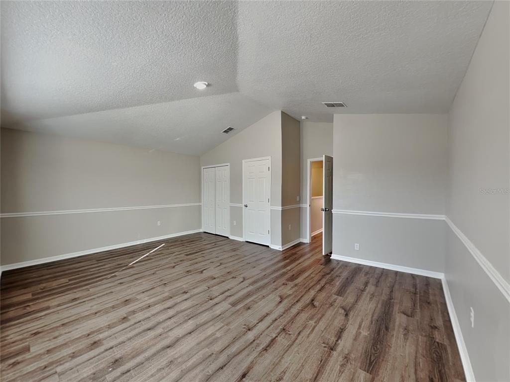Undisclosed Address Land O' Lakes, FL 34639 - Photo 5 of 25 wooden floor in an empty room with a window