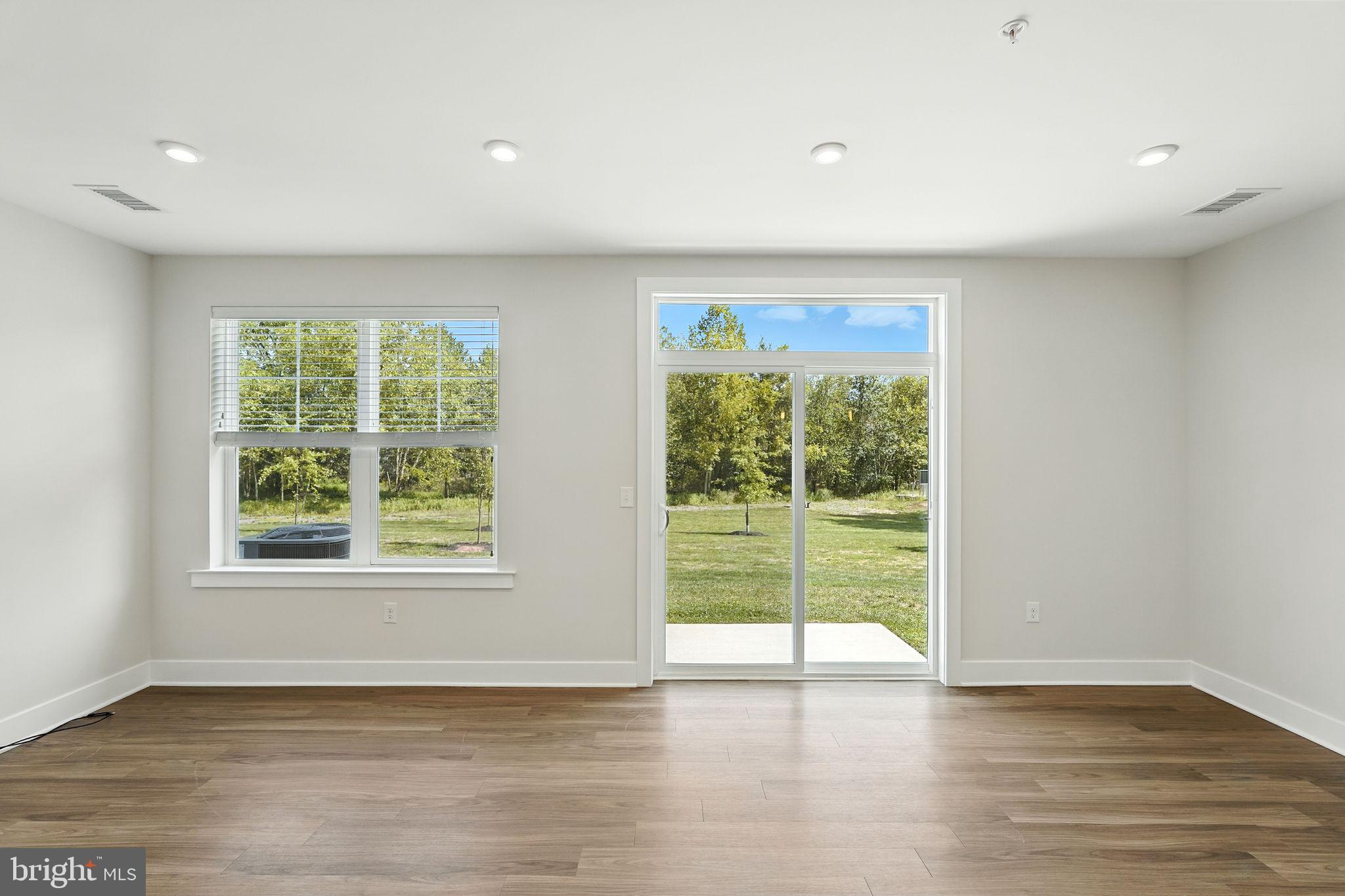 17 Mainland Road, Unit 115 Harleysville, PA 19438 - Photo 14 of 15 a view of an empty room with wooden floor and a window