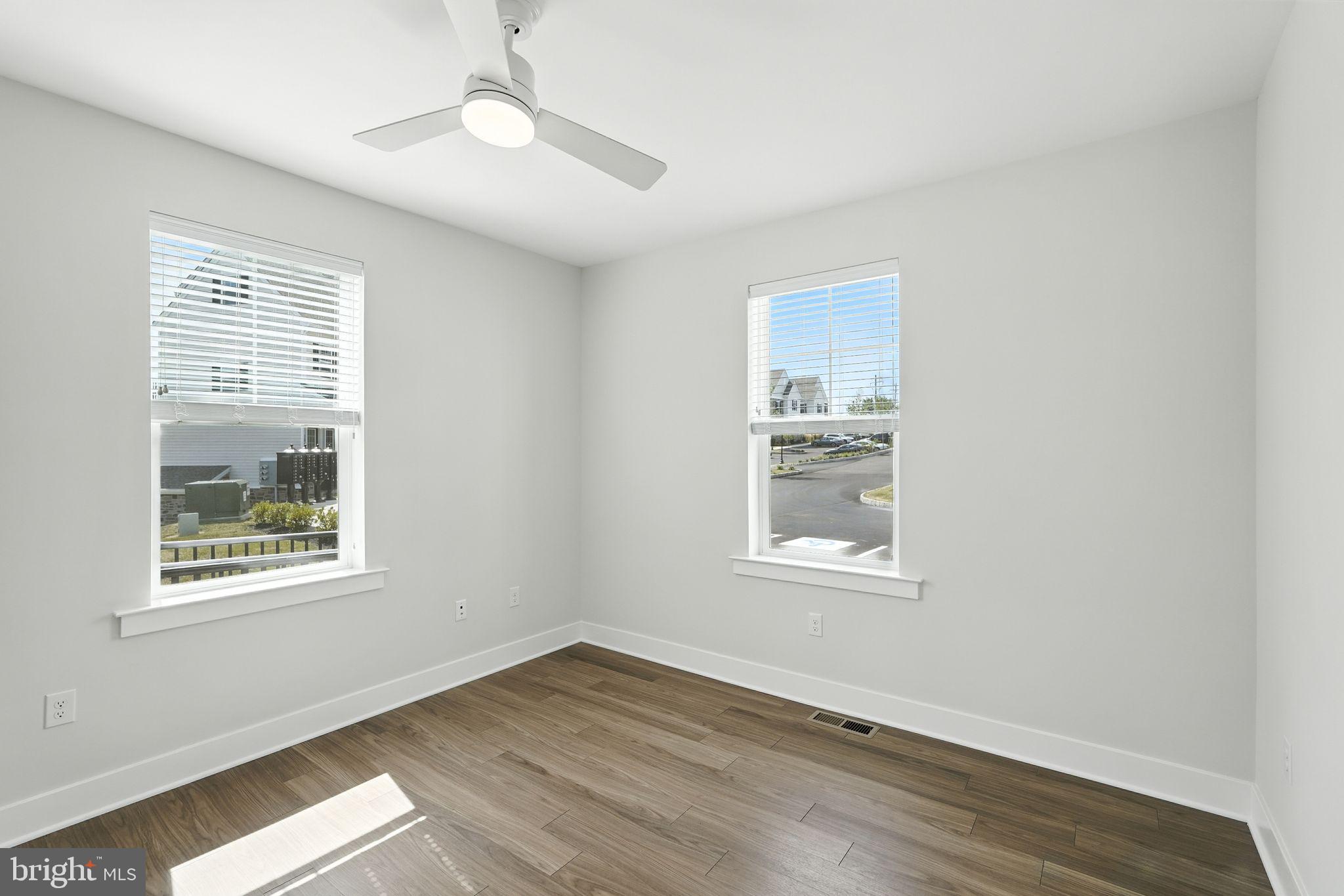 17 Mainland Road, Unit 115 Harleysville, PA 19438 - Photo 4 of 15 a view of an empty room with wooden floor and a window