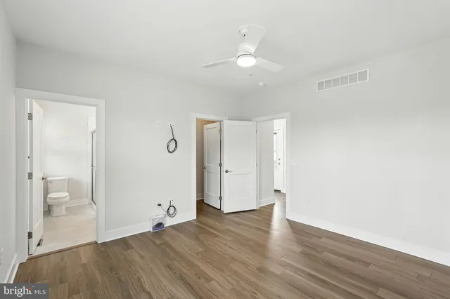 a view of an empty room and wooden floor