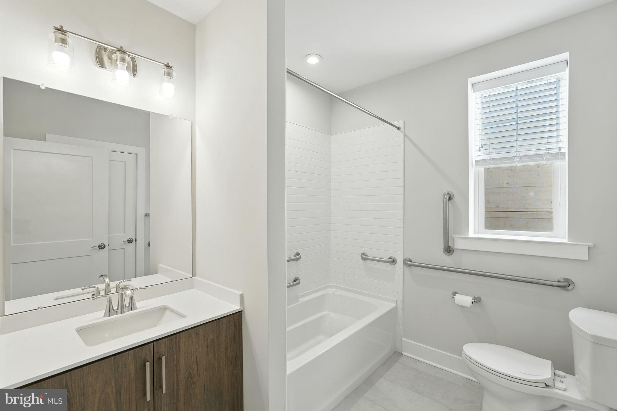 17 Mainland Road, Unit 115 Harleysville, PA 19438 - Photo 10 of 15 a bathroom with a granite countertop sink a toilet and shower