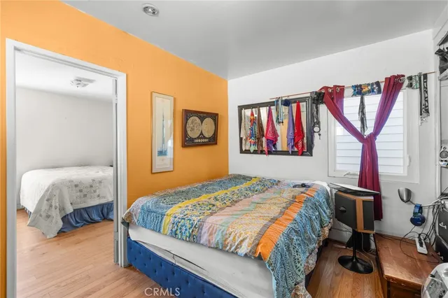a bedroom with a bed and a view of kitchen