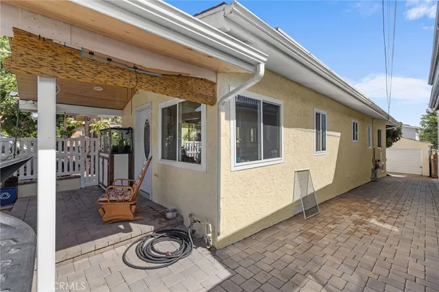 a view of a patio with table and chairs with wooden floor and fence