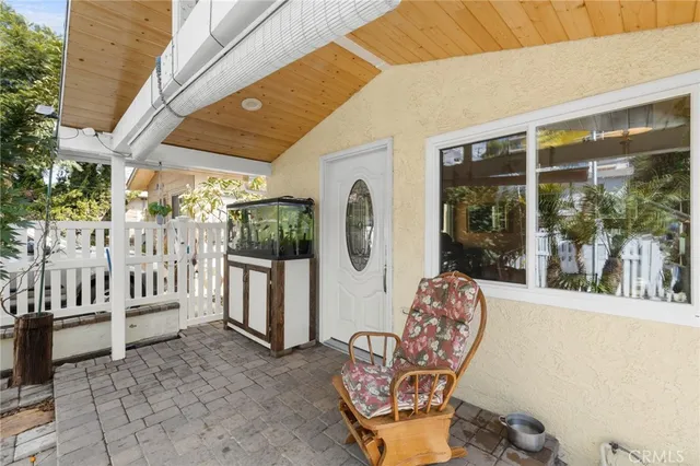 a side view of a house with a tree