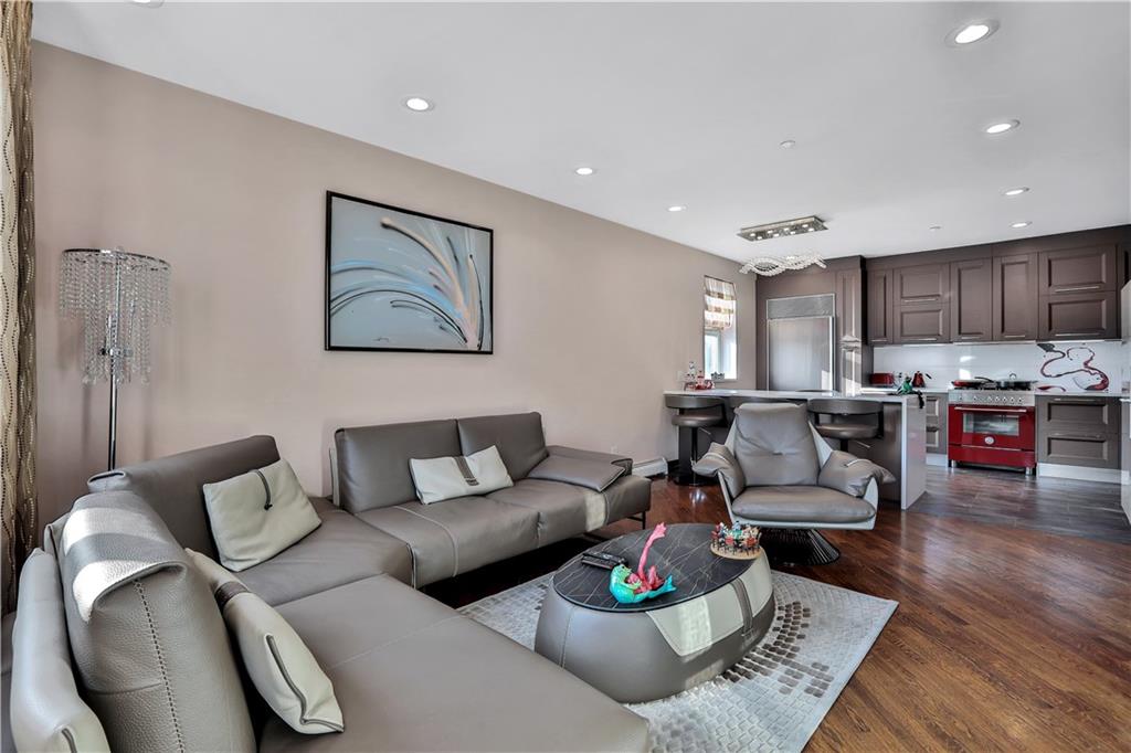 3392 Guider Avenue, Unit 8 Brooklyn, NY 11235 - Photo 2 of 22 a living room with furniture and kitchen view