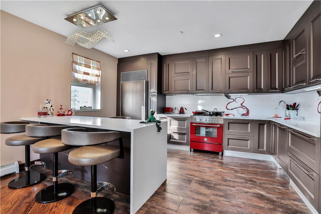 3392 Guider Avenue, Unit 8 Brooklyn, NY 11235 - Photo 3 of 22 a kitchen with granite countertop a sink cabinets and window