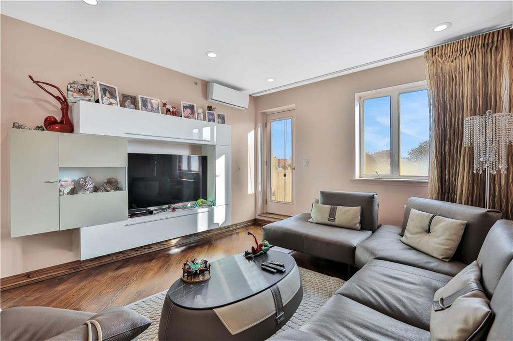 3392 Guider Avenue, Unit 8 Brooklyn, NY 11235 - Photo 6 of 22 a living room with furniture and a flat screen tv