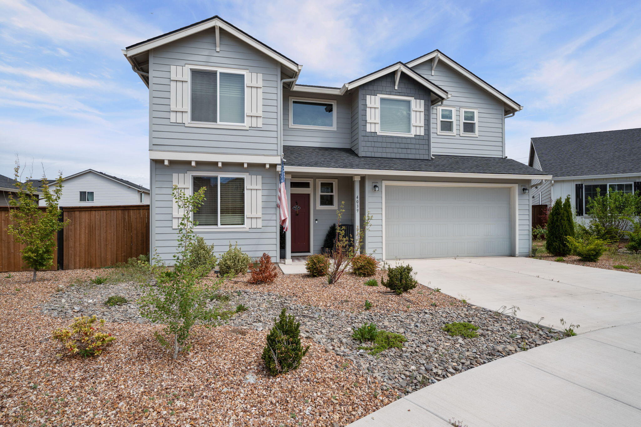 4039 Southwest Quartz Place Redmond, OR 97756 - Photo 2 of 44 a front view of a house with garden