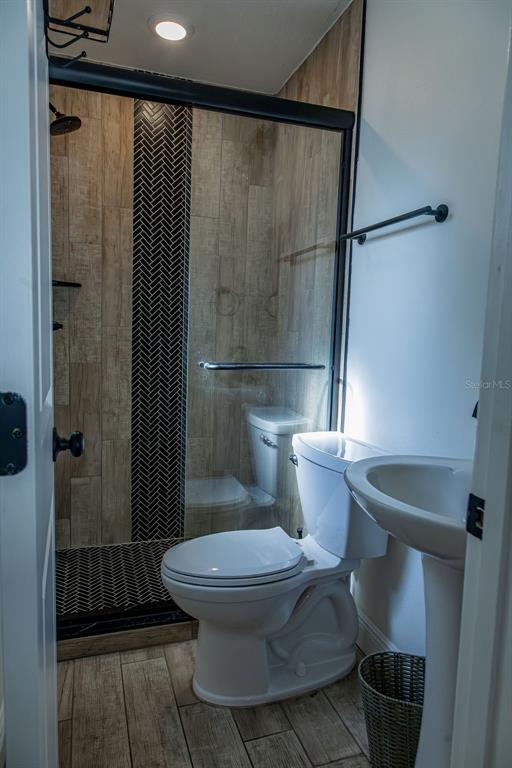 336 Lake Mabel Loop Road Lake Wales, FL 33898 - Photo 12 of 60 a bathroom with a toilet and a shower