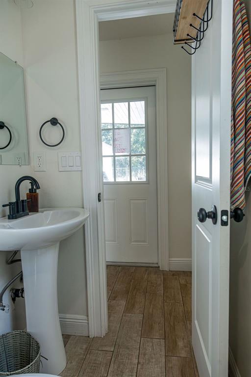 336 Lake Mabel Loop Road Lake Wales, FL 33898 - Photo 14 of 60 a bathroom with a sink a mirror and a shower