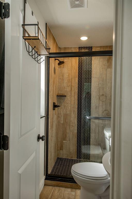 336 Lake Mabel Loop Road Lake Wales, FL 33898 - Photo 15 of 60 a bathroom with a toilet and a shower