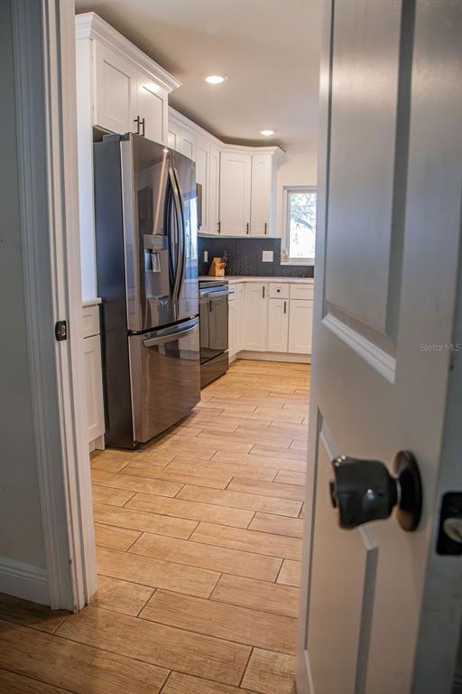336 Lake Mabel Loop Road Lake Wales, FL 33898 - Photo 16 of 60 a kitchen with stainless steel appliances a refrigerator and a stove top oven