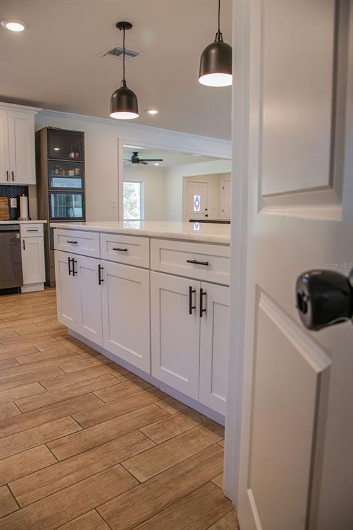 336 Lake Mabel Loop Road Lake Wales, FL 33898 - Photo 17 of 60 a kitchen with stainless steel appliances granite countertop a sink and cabinets with wooden floor