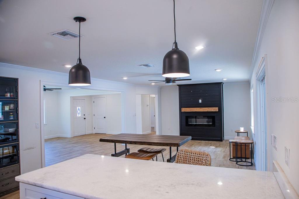 336 Lake Mabel Loop Road Lake Wales, FL 33898 - Photo 18 of 60 a living room with furniture and a chandelier