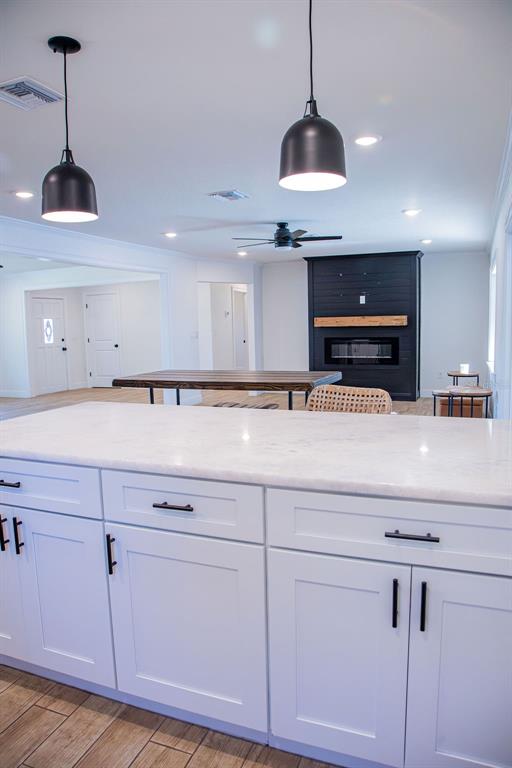 336 Lake Mabel Loop Road Lake Wales, FL 33898 - Photo 19 of 60 a kitchen with cabinets and chandelier