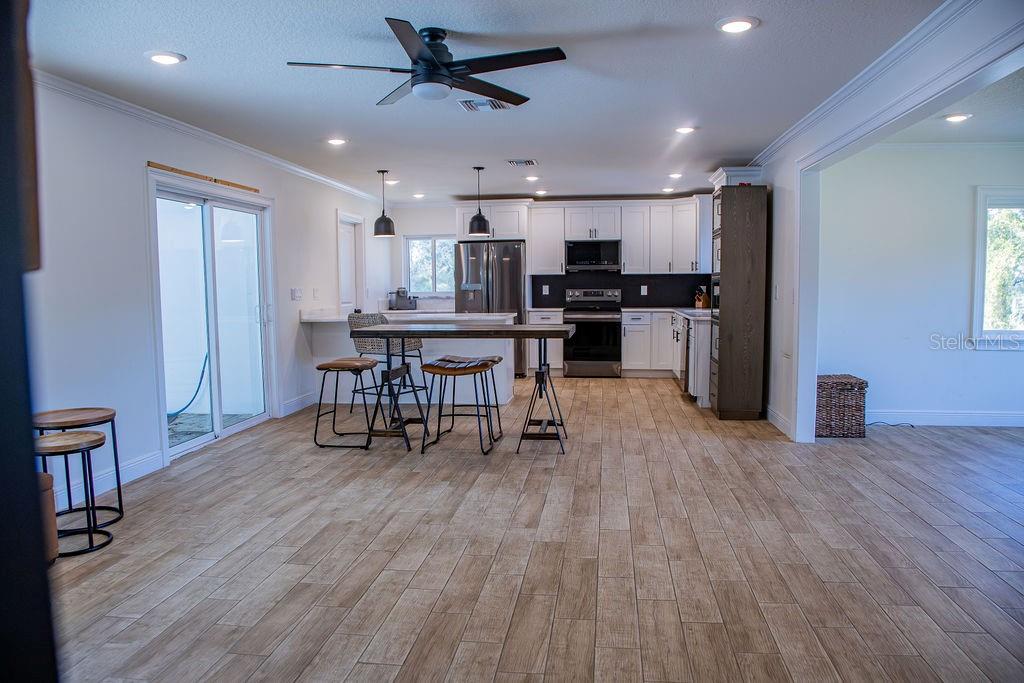 336 Lake Mabel Loop Road Lake Wales, FL 33898 - Photo 23 of 60 a view of kitchen with microwave and wooden floor