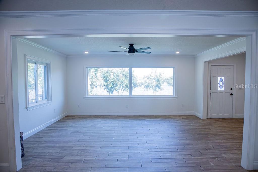 336 Lake Mabel Loop Road Lake Wales, FL 33898 - Photo 26 of 60 a view of an empty room with wooden floor and a window