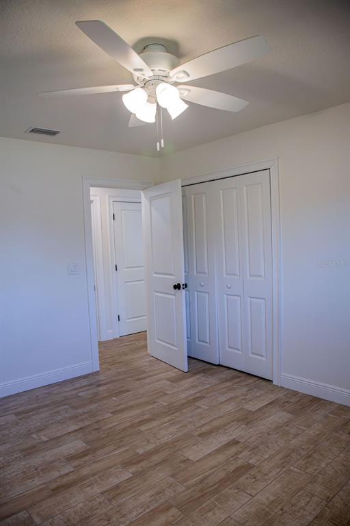 336 Lake Mabel Loop Road Lake Wales, FL 33898 - Photo 34 of 60 a view of an empty room with wooden floor