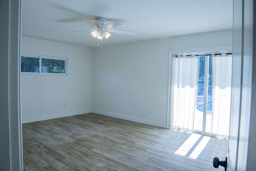 336 Lake Mabel Loop Road Lake Wales, FL 33898 - Photo 37 of 60 a view of an empty room with wooden floor and a window