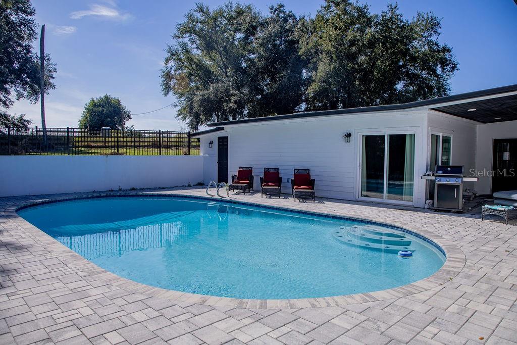 336 Lake Mabel Loop Road Lake Wales, FL 33898 - Photo 43 of 60 a view of a swimming pool with chair and table