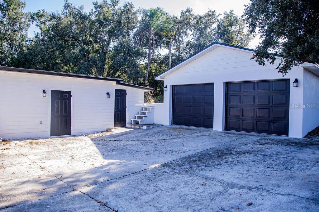 336 Lake Mabel Loop Road Lake Wales, FL 33898 - Photo 45 of 60 a view of a house with a yard and garage