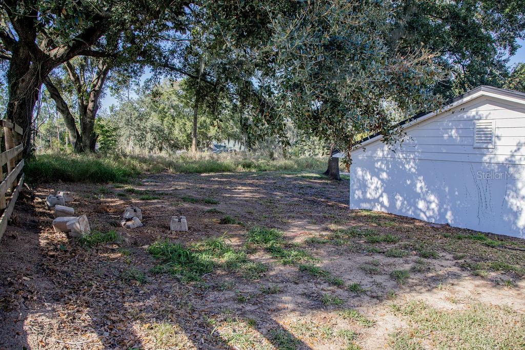 336 Lake Mabel Loop Road Lake Wales, FL 33898 - Photo 48 of 60 a backyard of a house with lots of green space