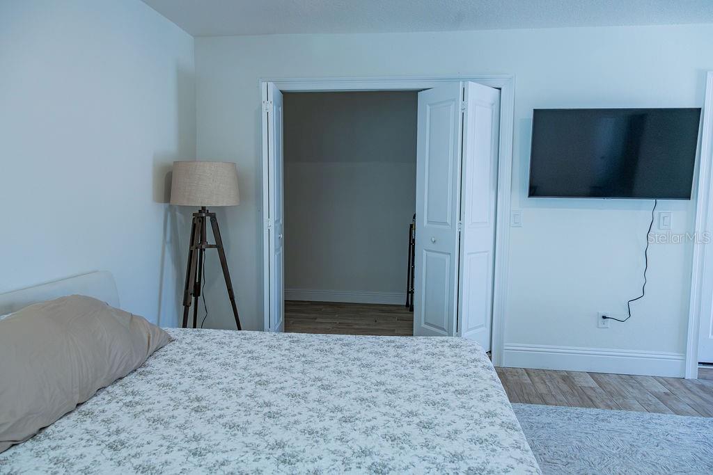 336 Lake Mabel Loop Road Lake Wales, FL 33898 - Photo 6 of 60 a bedroom with a bed and a flat screen tv