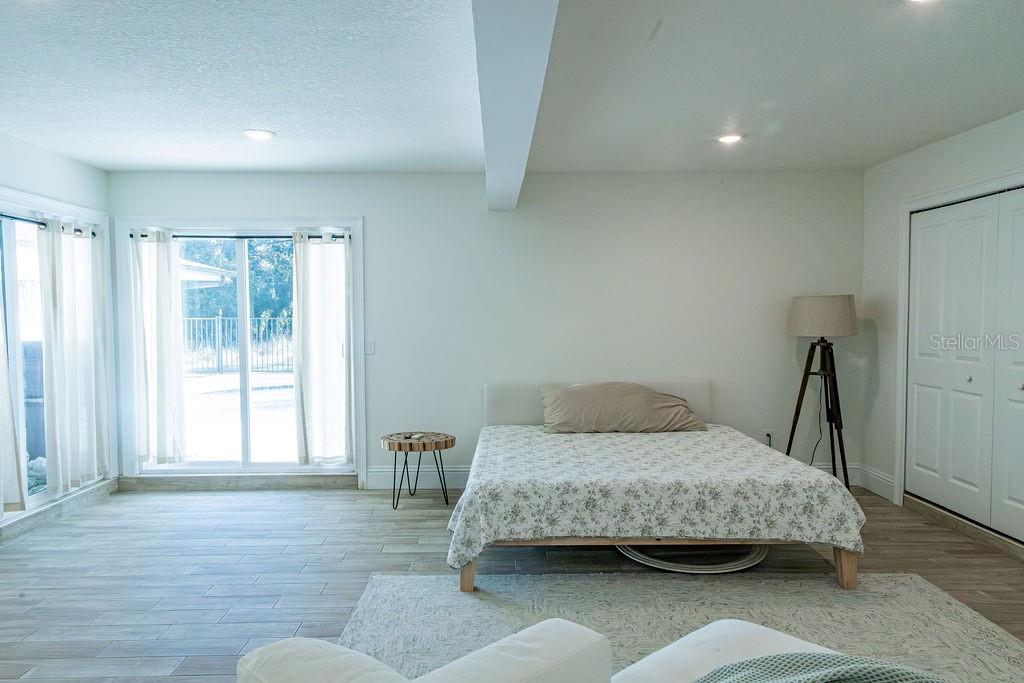 336 Lake Mabel Loop Road Lake Wales, FL 33898 - Photo 9 of 60 a bedroom with a bed and wooden floor