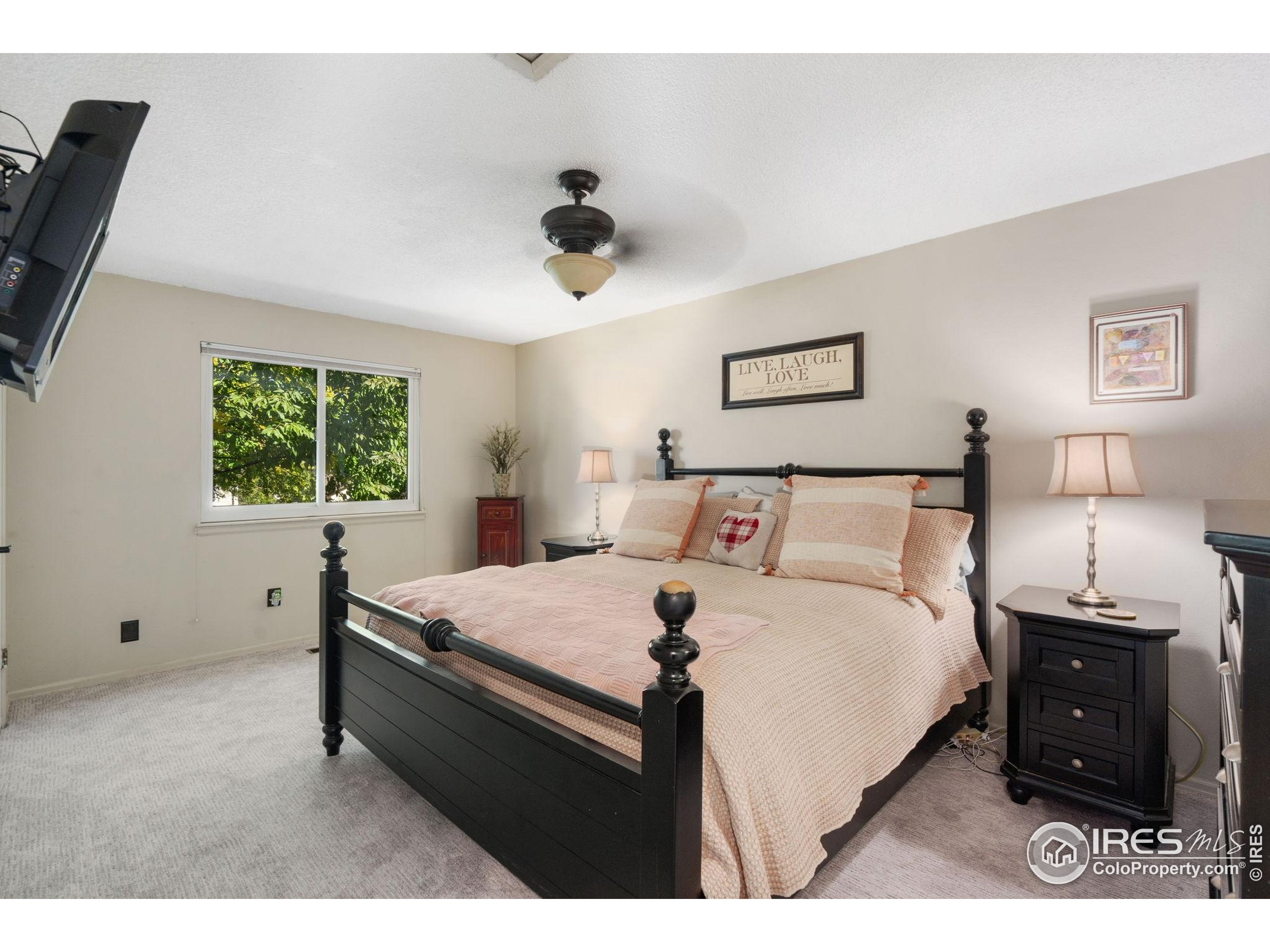 2500 Wapiti Road Fort Collins, CO 80525 - Photo 12 of 34 a bed room with a bed window and a night stand