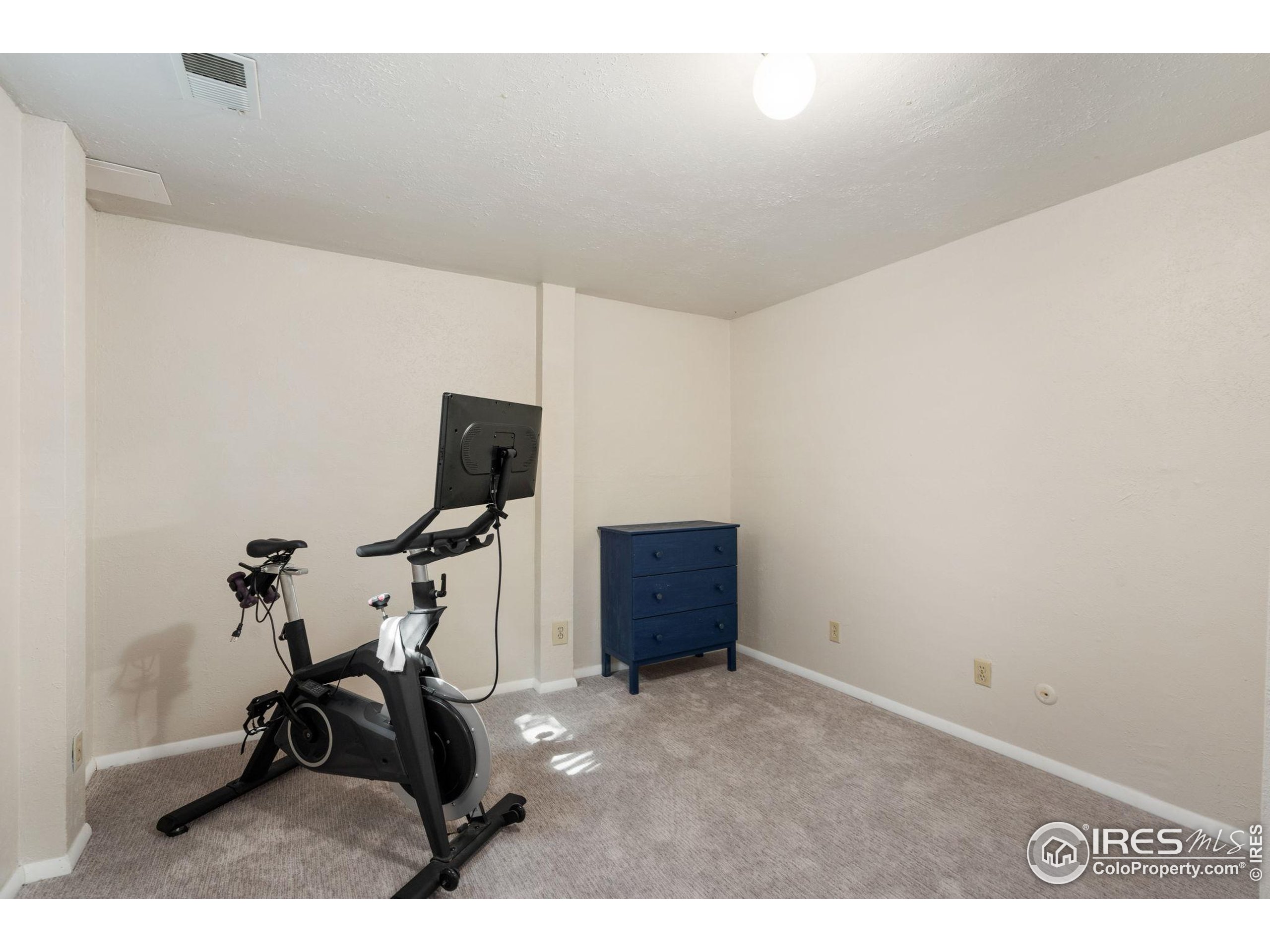 2500 Wapiti Road Fort Collins, CO 80525 - Photo 18 of 34 a room with gym equipment and a view of living room