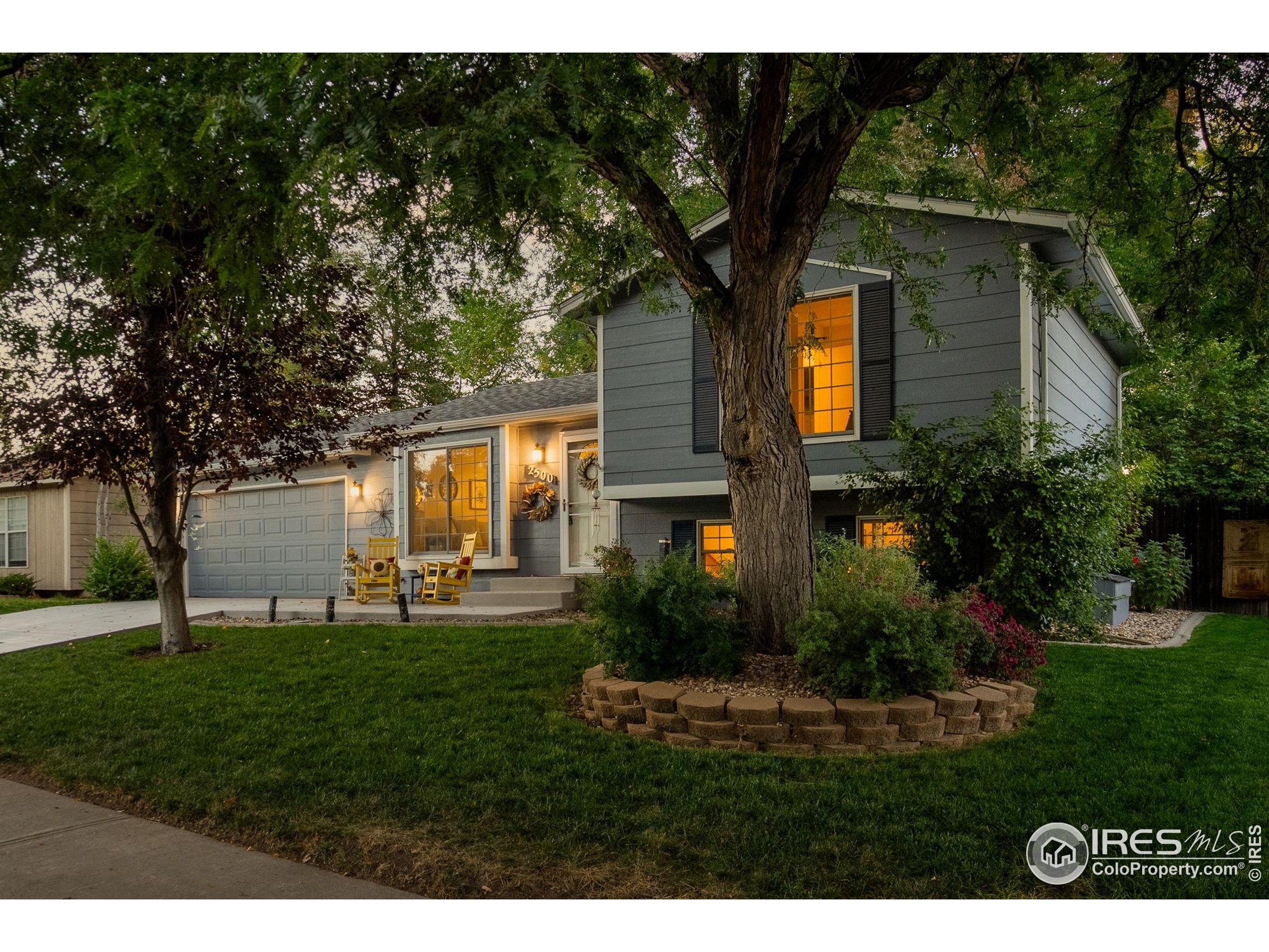 2500 Wapiti Road Fort Collins, CO 80525 - Photo 2 of 34 a front view of a house with garden and trees