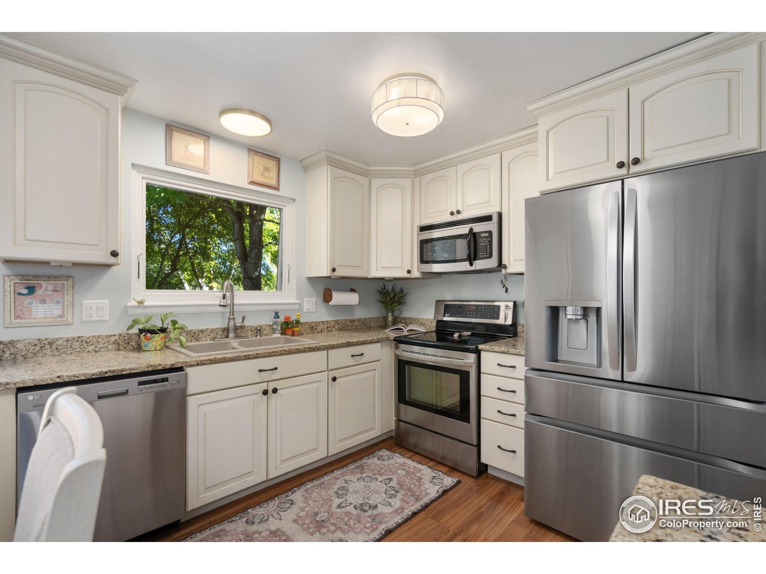 2500 Wapiti Road Fort Collins, CO 80525 - Photo 7 of 34 a kitchen with stainless steel appliances granite countertop a refrigerator sink and stove