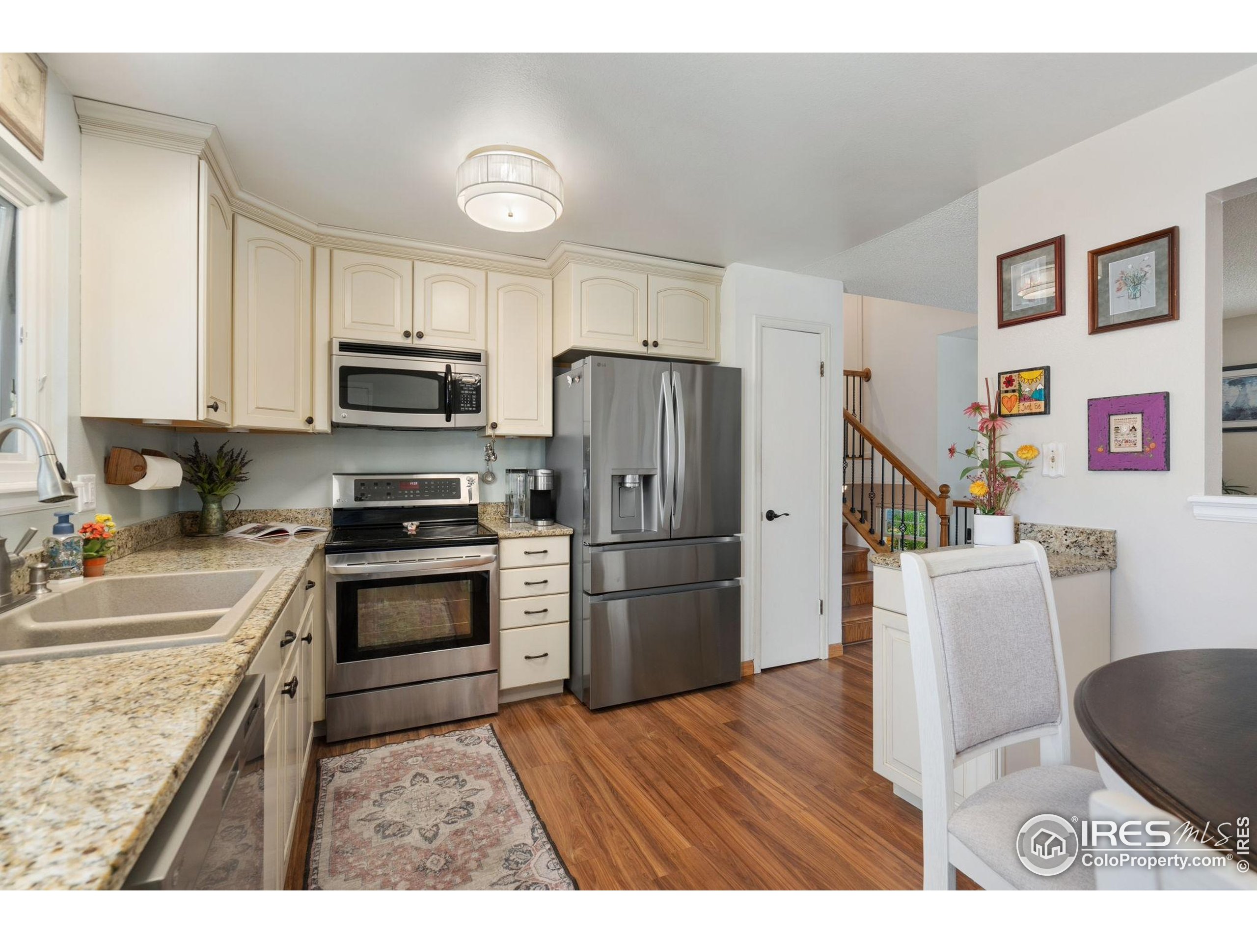2500 Wapiti Road Fort Collins, CO 80525 - Photo 8 of 34 a kitchen with granite countertop a refrigerator stove and sink
