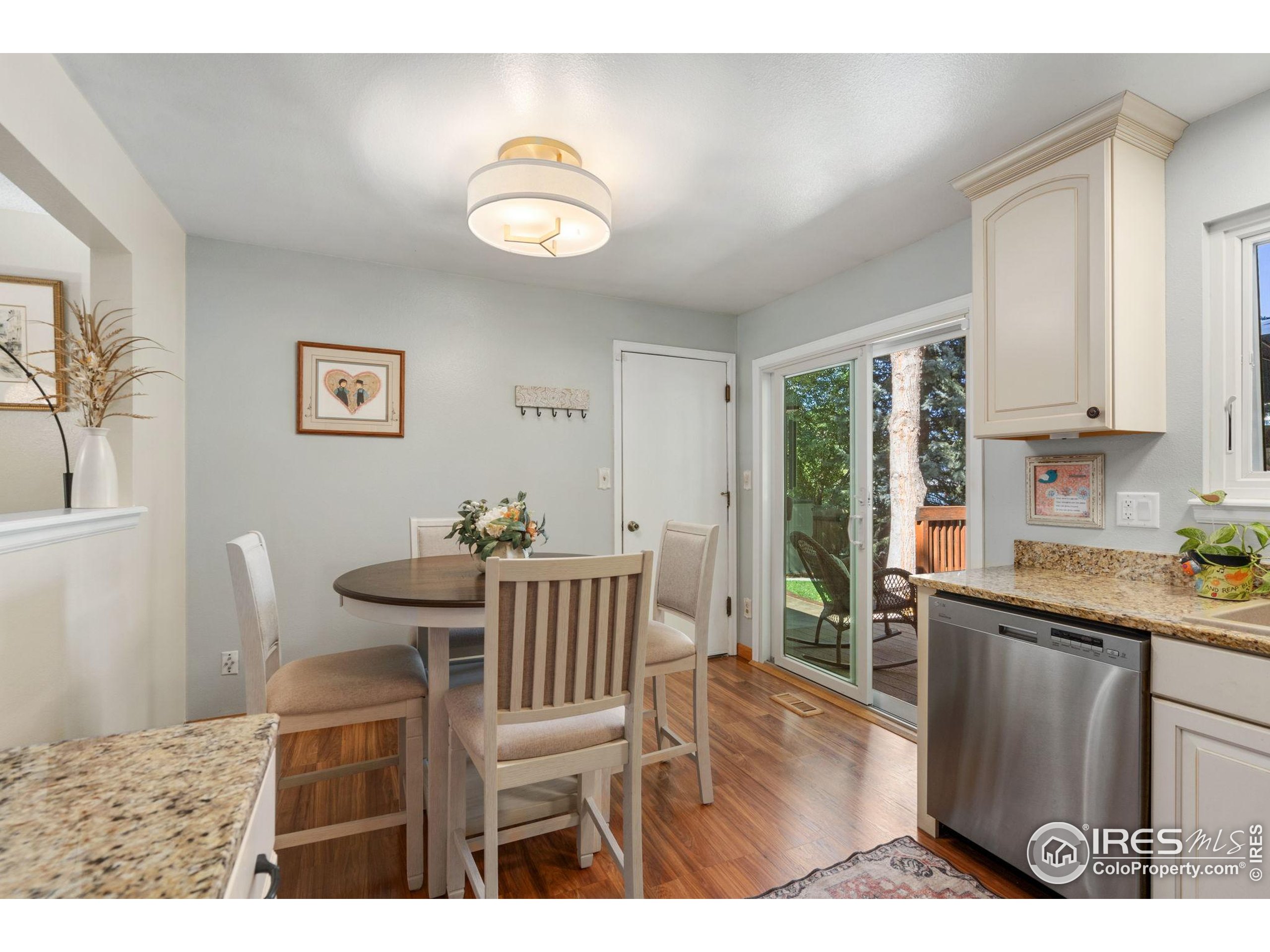 2500 Wapiti Road Fort Collins, CO 80525 - Photo 9 of 34 a view of a dining room with furniture window and wooden floor