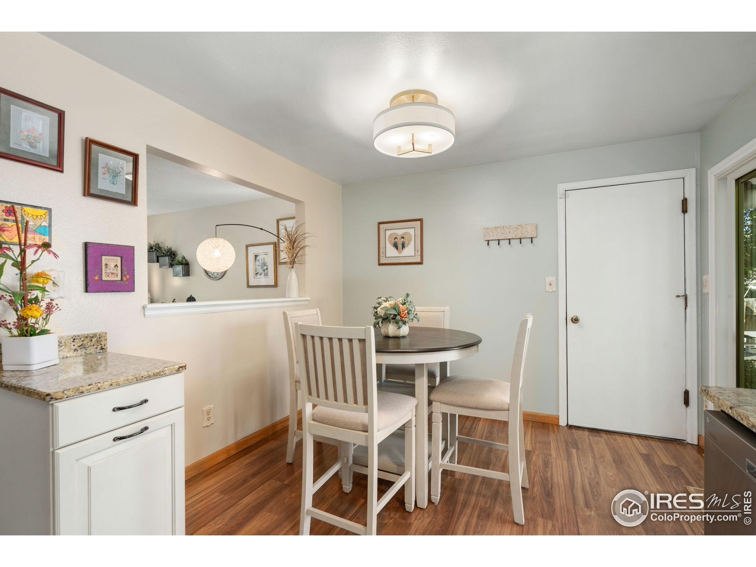 2500 Wapiti Road Fort Collins, CO 80525 - Photo 10 of 34 a view of a dining room with furniture and wooden floor