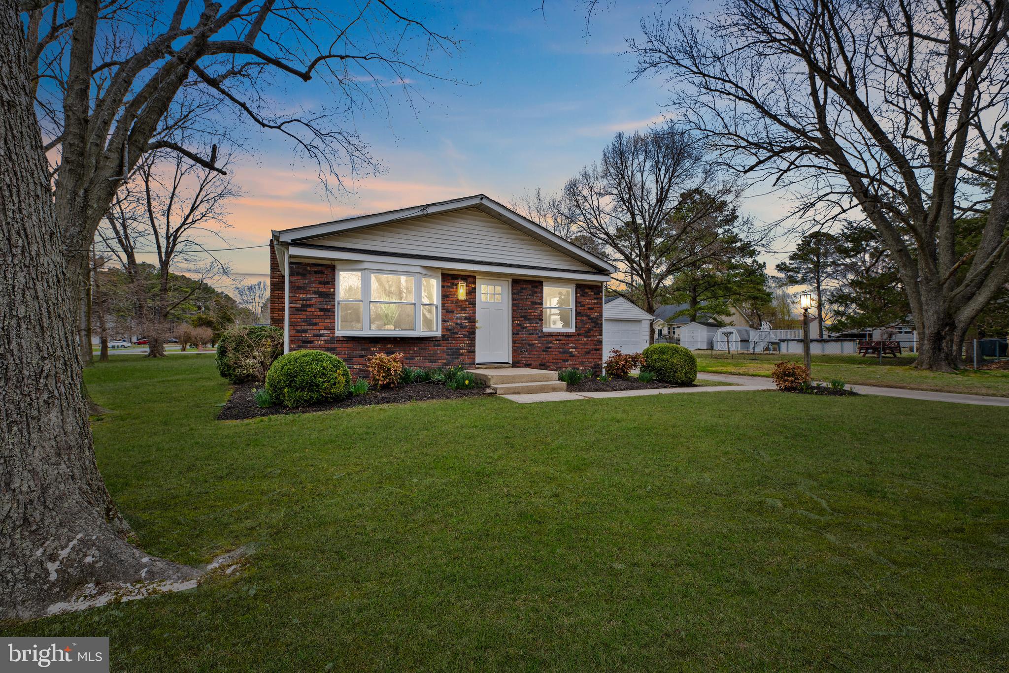 a front view of house with yard and green space