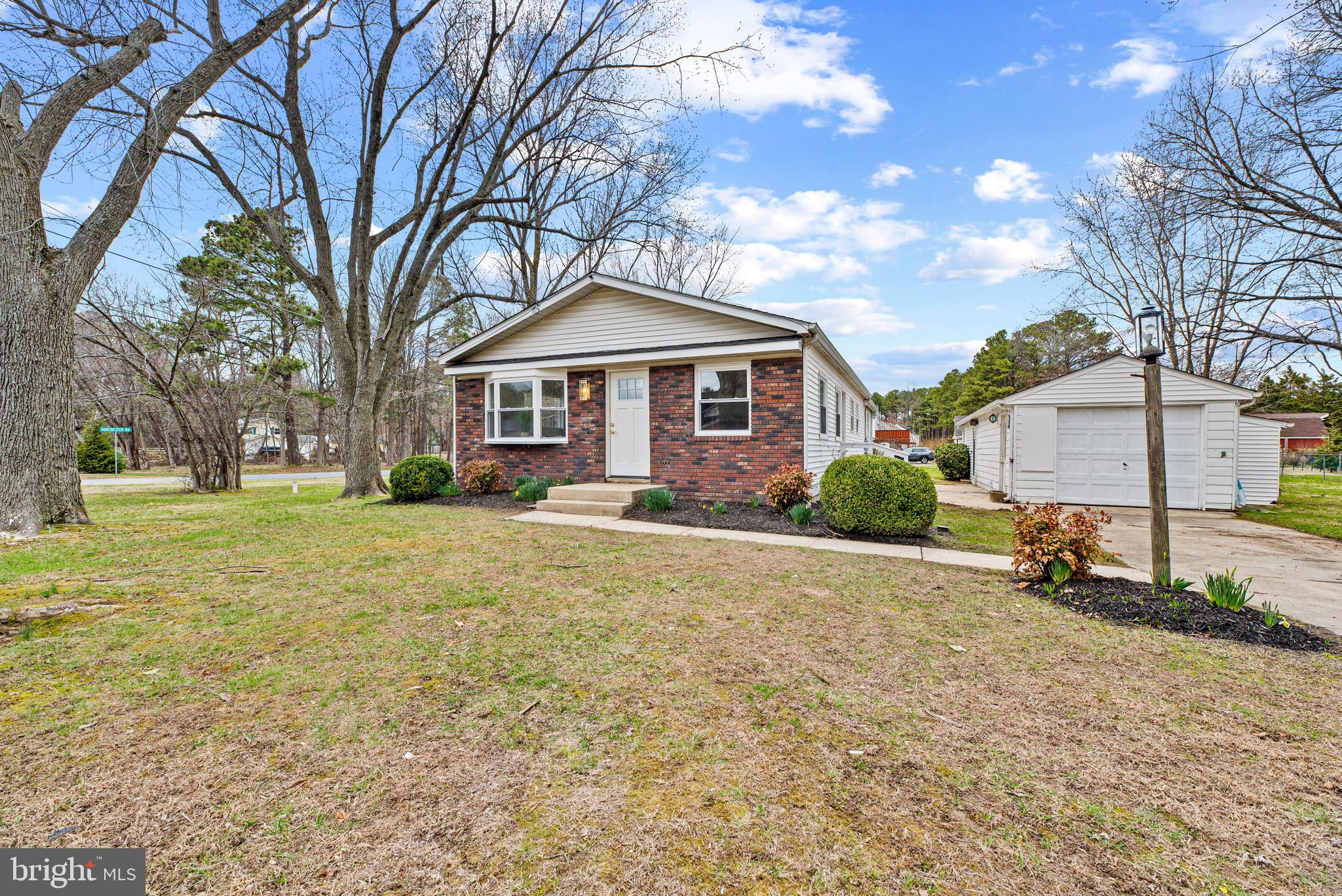 9401 Romancoke Road Stevensville, MD 21666 - Photo 11 of 40 a front view of a house with a yard and garage