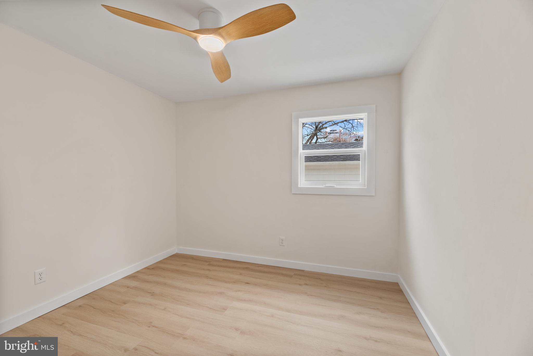9401 Romancoke Road Stevensville, MD 21666 - Photo 23 of 40 an empty room with wooden floor and window