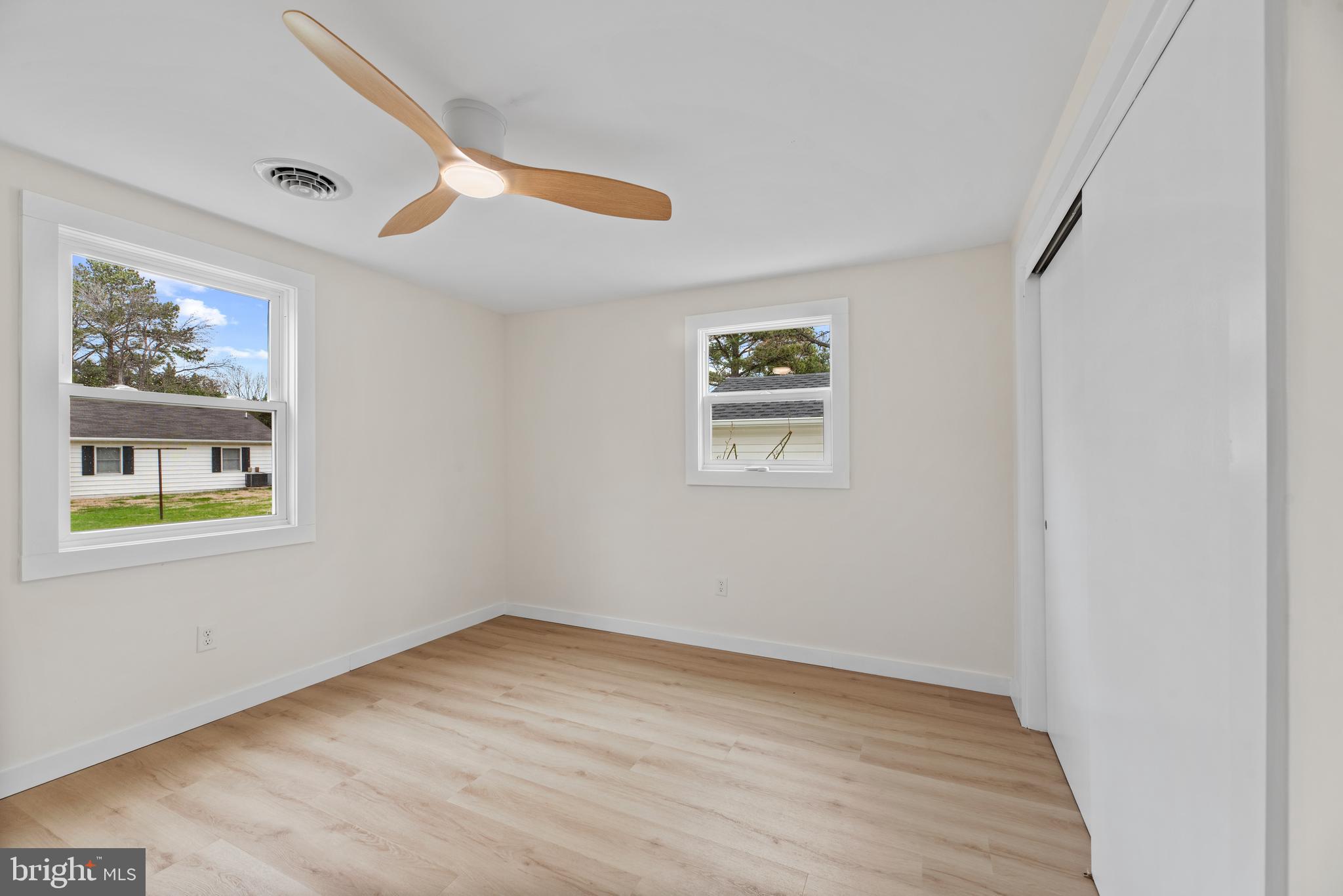9401 Romancoke Road Stevensville, MD 21666 - Photo 25 of 40 an empty room with a window and wooden floor