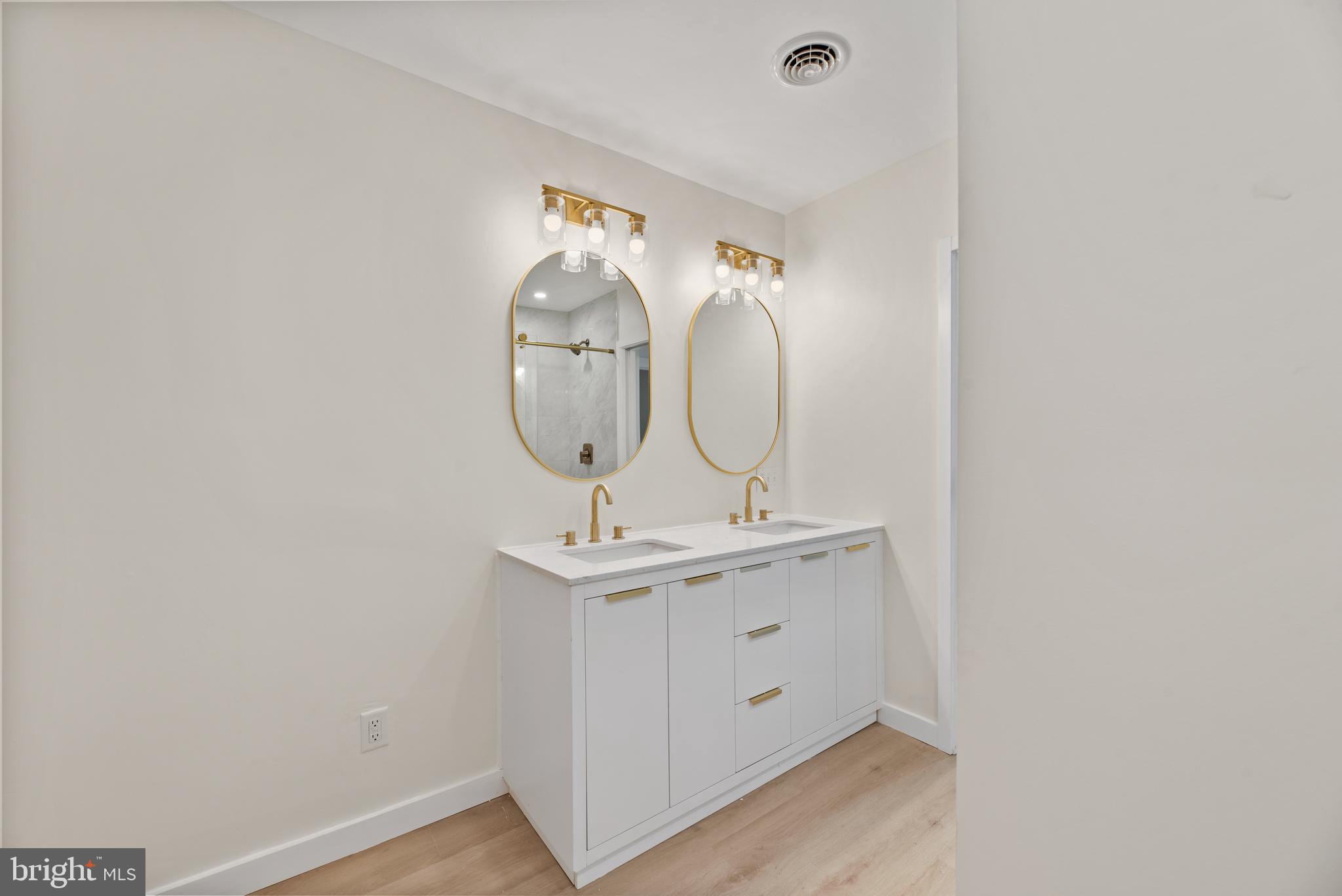 9401 Romancoke Road Stevensville, MD 21666 - Photo 9 of 40 a room with a mirror and a sink