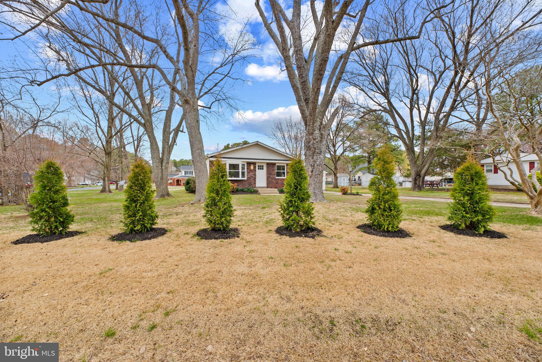 9401 Romancoke Road Stevensville, MD 21666 - Photo 10 of 40 front view of a house with a yard and potted plants