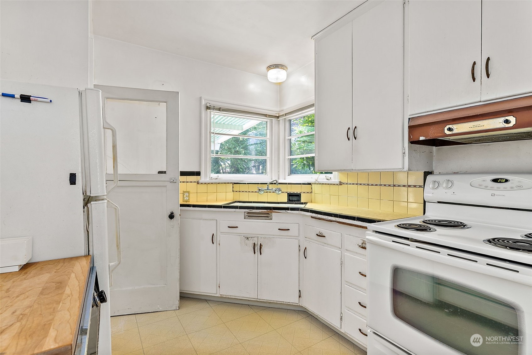 1405 Morris Avenue South Renton, WA 98055 - Photo 7 of 27 a kitchen with granite countertop white cabinets and white appliances