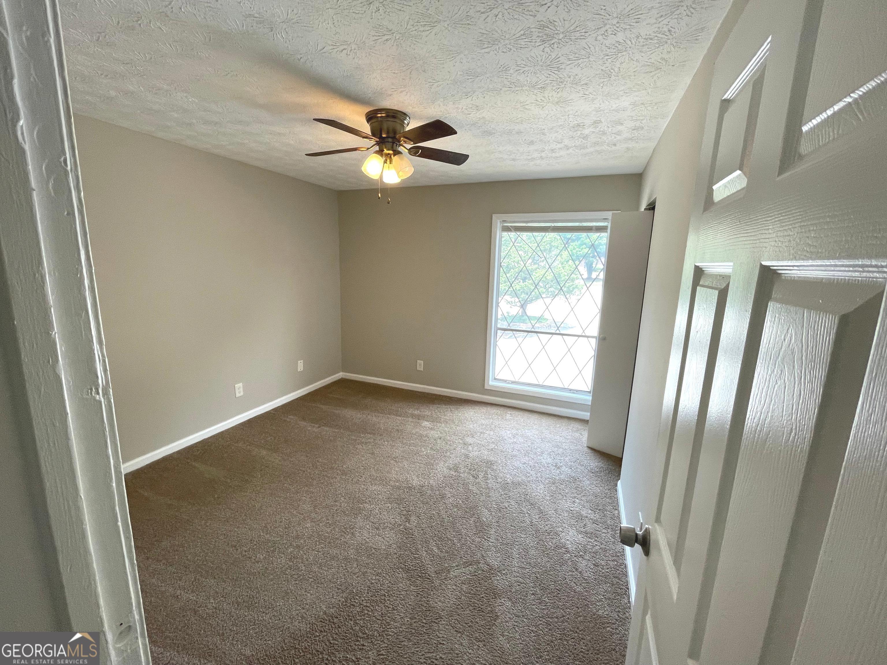 3192 Abbeywood Drive Decatur, GA 30034 - Photo 17 of 17 an empty room with windows and fan