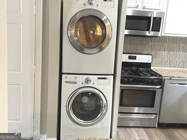 a view of a storage and utility room with washer and dryer