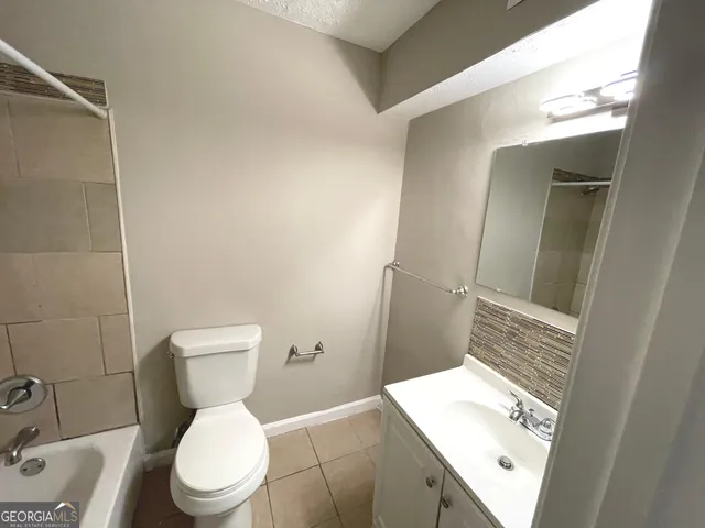 a white toilet sitting next to a bathroom sink