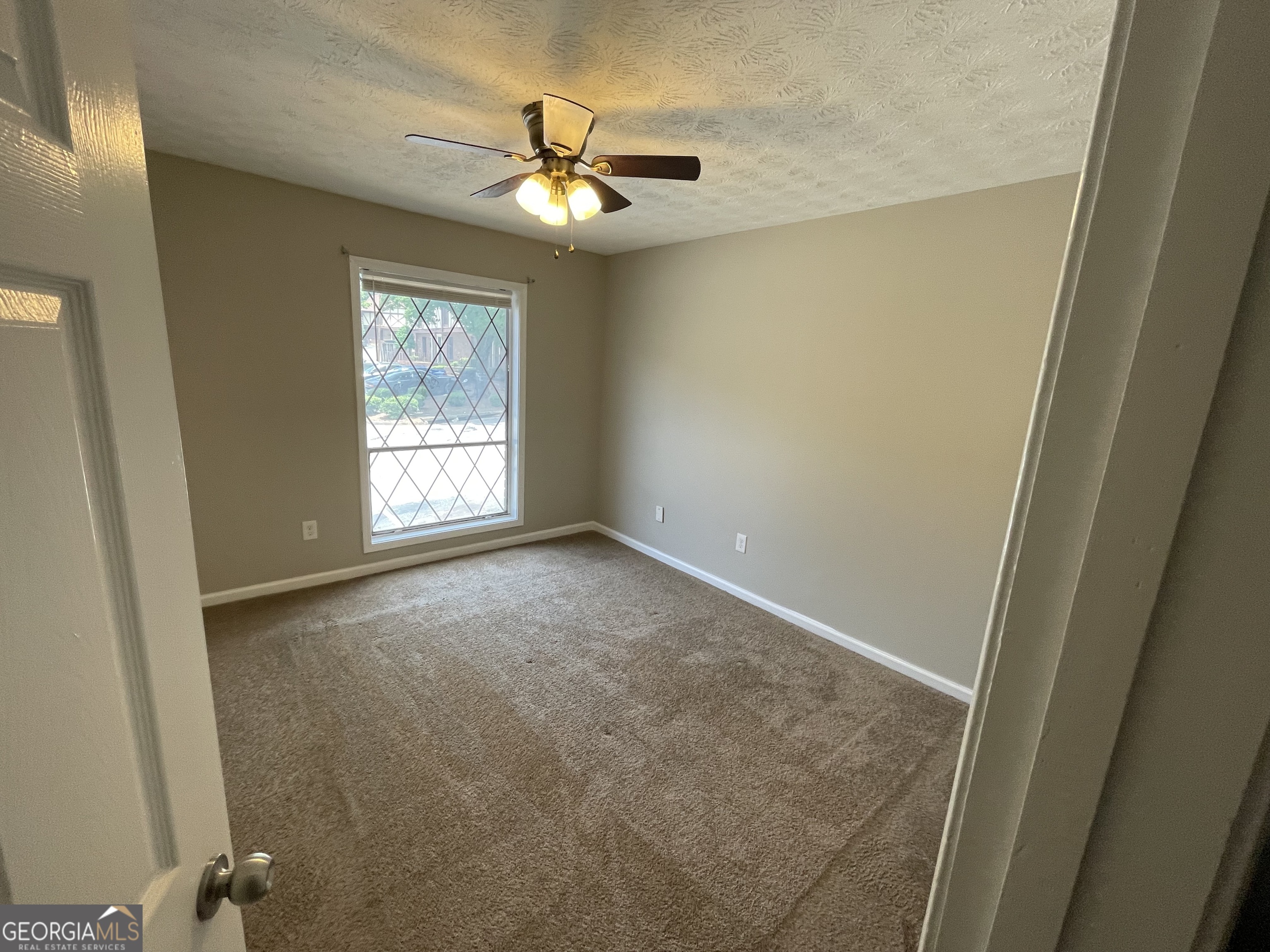 3192 Abbeywood Drive Decatur, GA 30034 - Photo 6 of 17 an empty room with windows and chandelier
