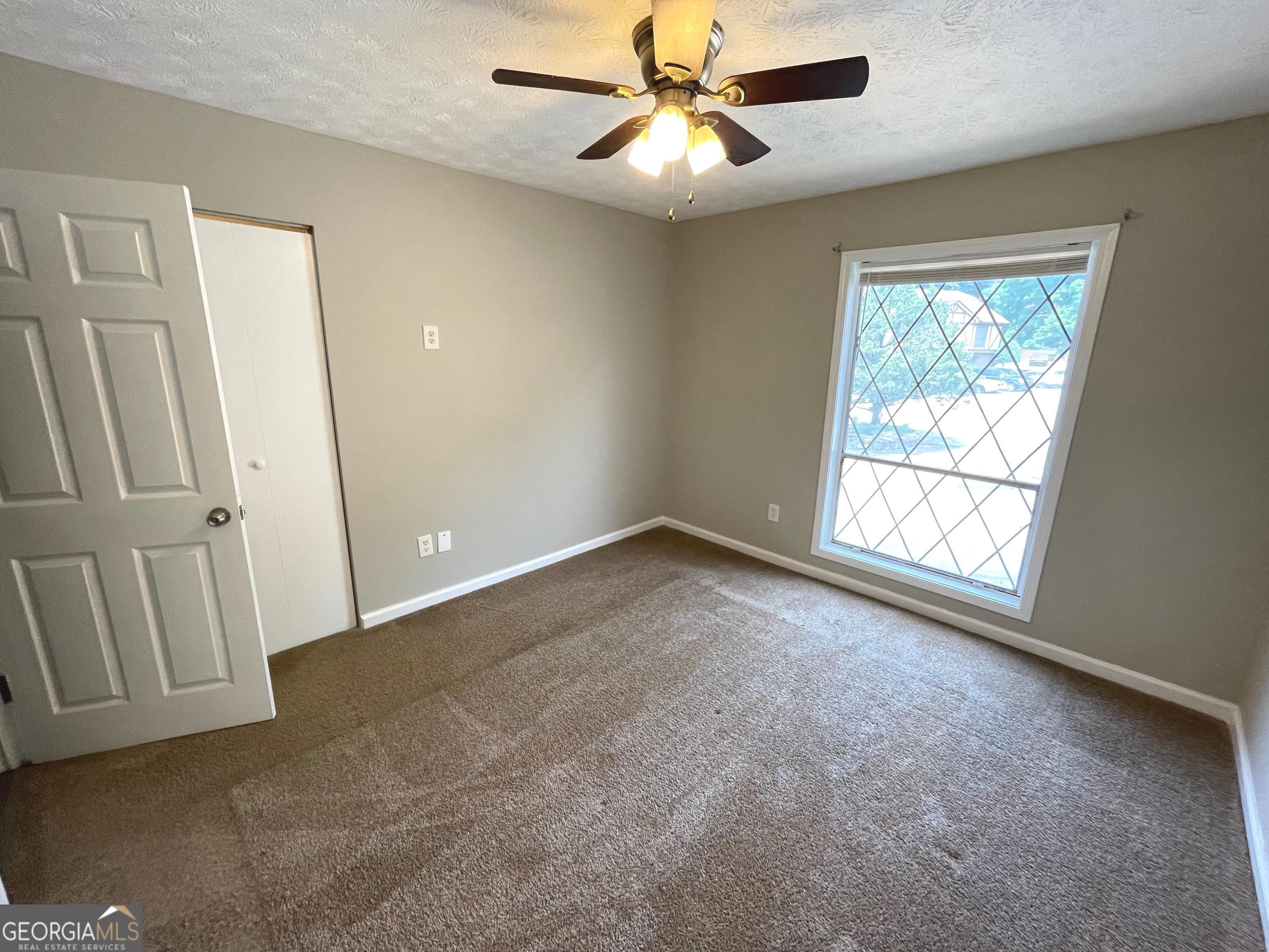 3192 Abbeywood Drive Decatur, GA 30034 - Photo 10 of 17 an empty room with windows and fan