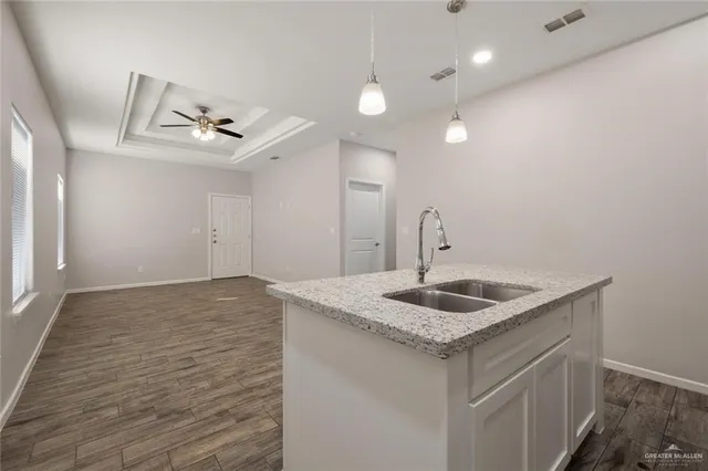 a kitchen with sink cabinets and chandelier