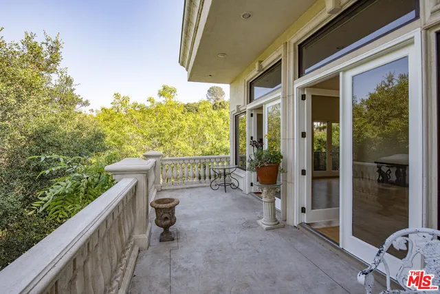 a view of a chair and tables in the balcony