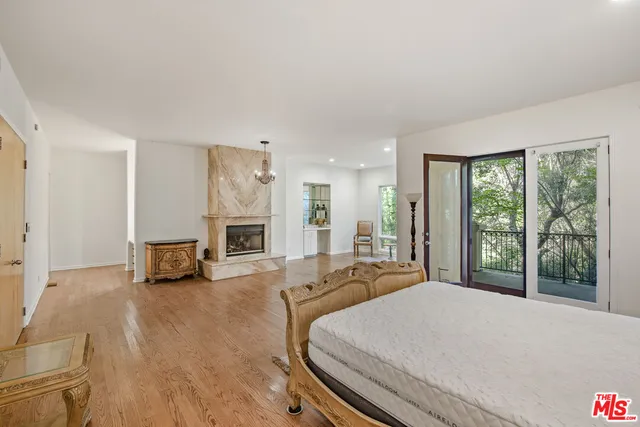 a bedroom with a bed and a fireplace